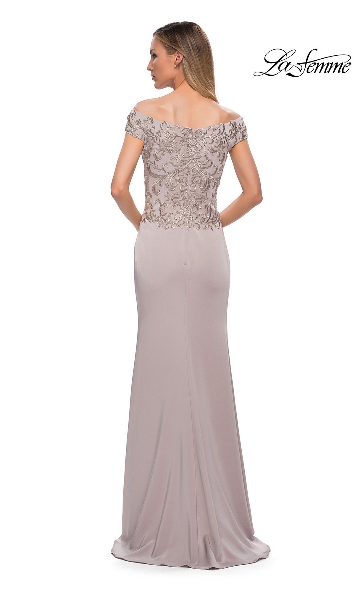 Woman wearing the Long Formal Dress: La Femme 29331—taupe, fitted embroidered bodice, off-the-shoulder neckline—stands with her back to the camera.